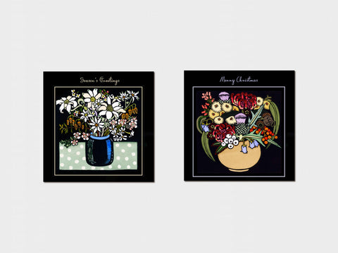 Two floral art prints with 'Season's Greetings' and 'Merry Christmas' text on a white background.