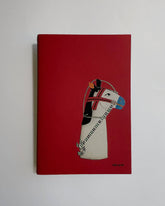 A red hardcover notebook or journal featuring a stylized illustration of a zebra wearing a helmet on the front cover, photographed against a plain light gray background.