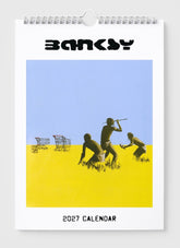 2027 calendar with artwork by Banksy featuring three figures and shopping carts on a blue and yellow background.