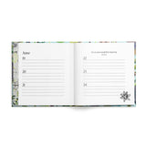 Open pages of a book with illustrated edges and lines for June