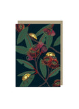 Black card with red blossom, green leaves and gold beetles.