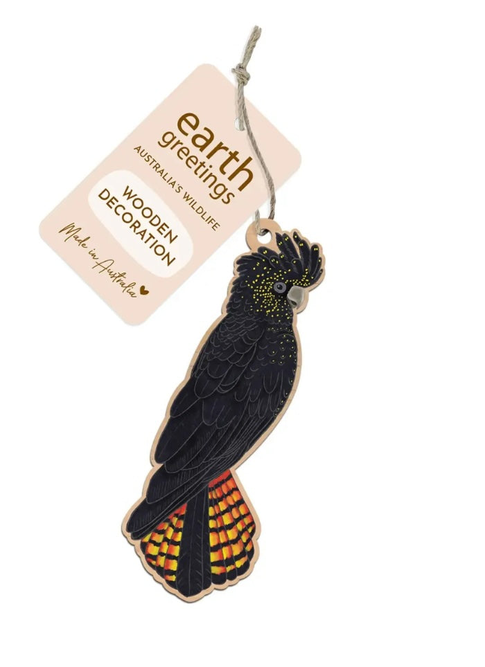 Wooden parrot decoration with 'earth greetings' tag on a white background
