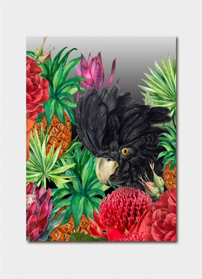 Black cockatoo surrounded by tropical flowers and leaves on a reflective surface