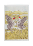 Two cranes with red chests in a field with mountains in the background