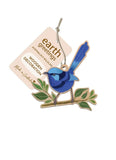 Blue bird decoration on a branch with 'earth greetings' tag on a white background