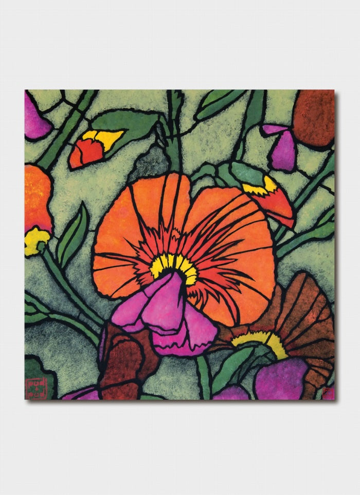 A pink and orange flower on a background of green leaves and coloured buds