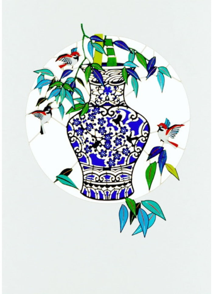 Decorative plate with blue and white vase design and colorful birds on a white background