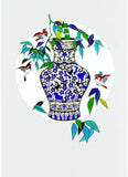 Decorative plate with blue and white vase design and colorful birds on a white background