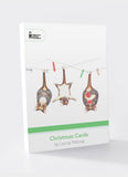 Pack of Christmas cards with hanging reindeer design on a white background