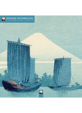 Japanese woodblock print with two boats and Mount Fuji in the background