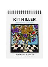 Front cover of Kit Hiller Desk Calendar with a vase and olourful flowers on a checked tabletop.