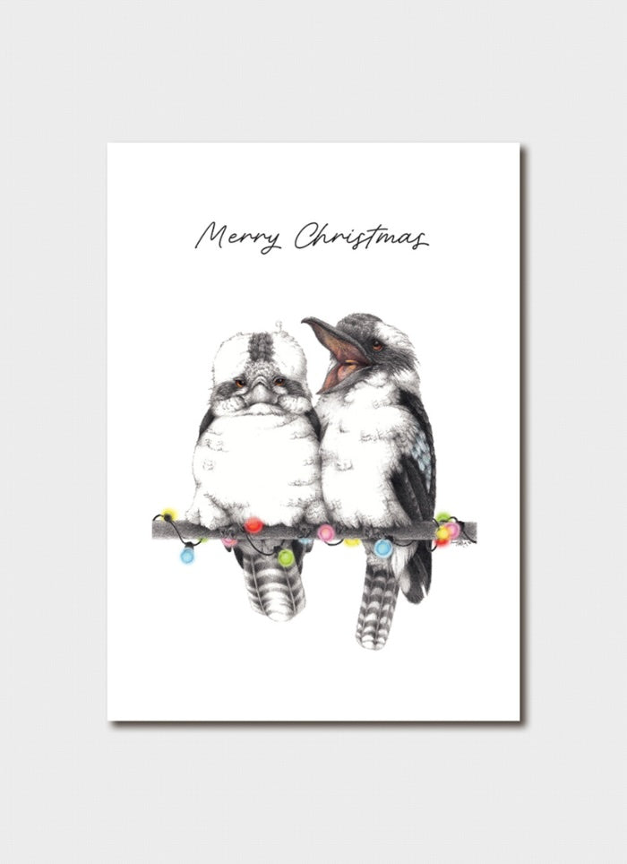 A white card with 2 kookaburras sitting on a branch with fairy lights.