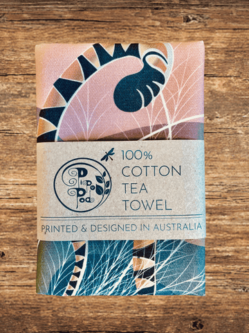 Tea towel with a decorative design on a wooden surface