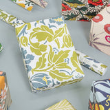Colorful floral-patterned boxes on a gray surface