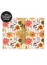 Gift box with floral design and gold ribbon, featuring '100% Melbourne Designed & Made' label.