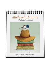 2027 desk calendar by Michaela Laurie with a bird on a hat and books design.
