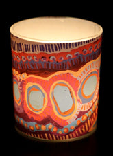 Decorative candle holder with colorful patterns on a black background