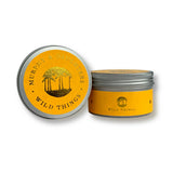 Two round metal tins for Murrey & Daughters Wild Things, one showing the lid with a yellow and gold label and the other showing the side label, on a white background.