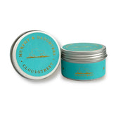 Two round metal tin containers for a candle, shown on a white background. One tin is open, displaying a turquoise label with gold text reading 'MURHIT & DAUGHTERS CLOUDSTREET'. Murphy & Daughters Travel Candle - Wild Things