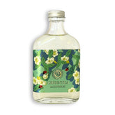 Bottle of green tea with floral label on a white background