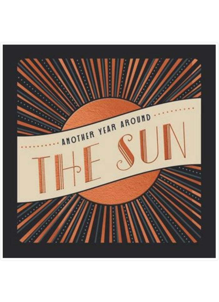 Decorative card with sun design and text 'Another Year Around The Sun' on a black background