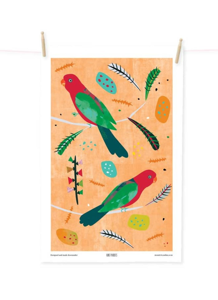 Decorative tea towel with colorful parrot design on an orange background