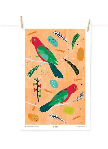 Decorative tea towel with colorful parrot design on an orange background
