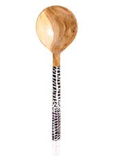 Wooden spoon with a patterned handle on a white background