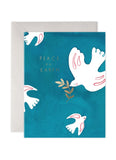 Greeting card with doves and 'Peace on Earth' text on a blue background