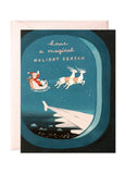 Blue card with a picture of sata and his reindeer.