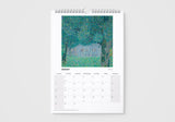Calendar with a painting of a house in a forest on a white background