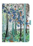 Notebook with a colorful forest design on the cover