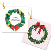 2 gift tags with a green wreath with red and gold ribbon and the words merry Christmas.