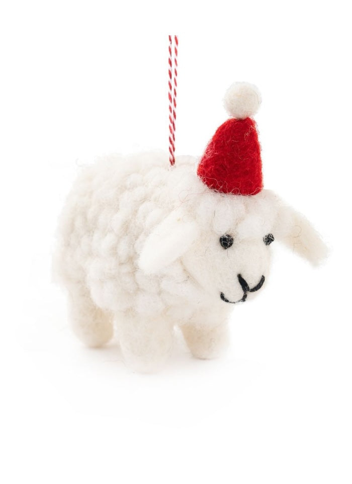 White sheep ornament with a red Santa hat on a white background