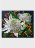 Close-up of a white flower with green leaves and orange accents on a dark background