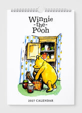Winnie-the-Pooh calendar for 2027 with a cartoon illustration of Pooh by a shelf.