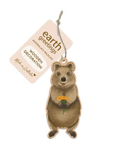 Wooden decoration of a bear holding a flower with 'earth greetings' tag on a white background