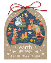 A Christmas-themed gift tag set with a kraft paper design, featuring an illustrated scene of a koala, kangaroo, and possum with gifts on a dark blue background, with the text 'earth greetings 8 CHRISTMAS GIFT TAGS' and a red string bow at the top.
