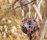 Bess Napanangka Christmas bauble hanging outside on a tree in the Australian bush