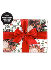 Gift wrap with floral design and red ribbon, featuring '100% Melbourne Designed & Made' label.