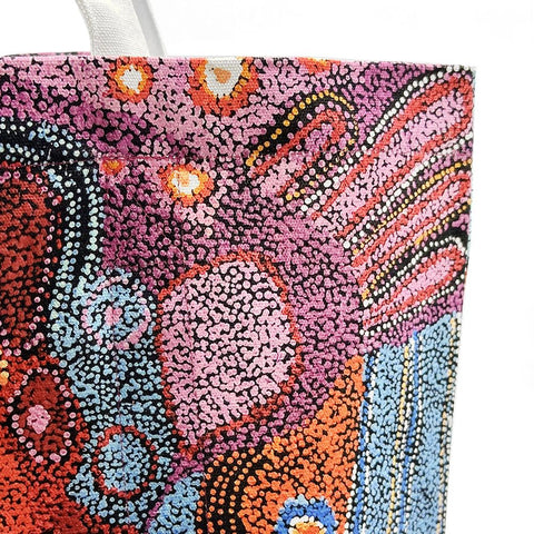 Close up of a canvas tote bag from Better World Arts and based on artwork by Andrea Mimpitja Adamson