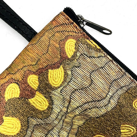 Embroidered pouch with a turtle design on a white background