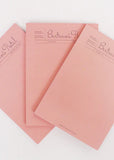 Set of pink notebooks with 'Bertram's' branding on a white background