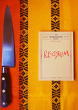 Knife and book titled 'Regain' on a patterned orange surface