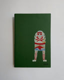 Green notebook with a graphic design of a character holding a British flag on a white background