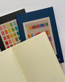 Notebook with colorful pages and a color swatch on a white background