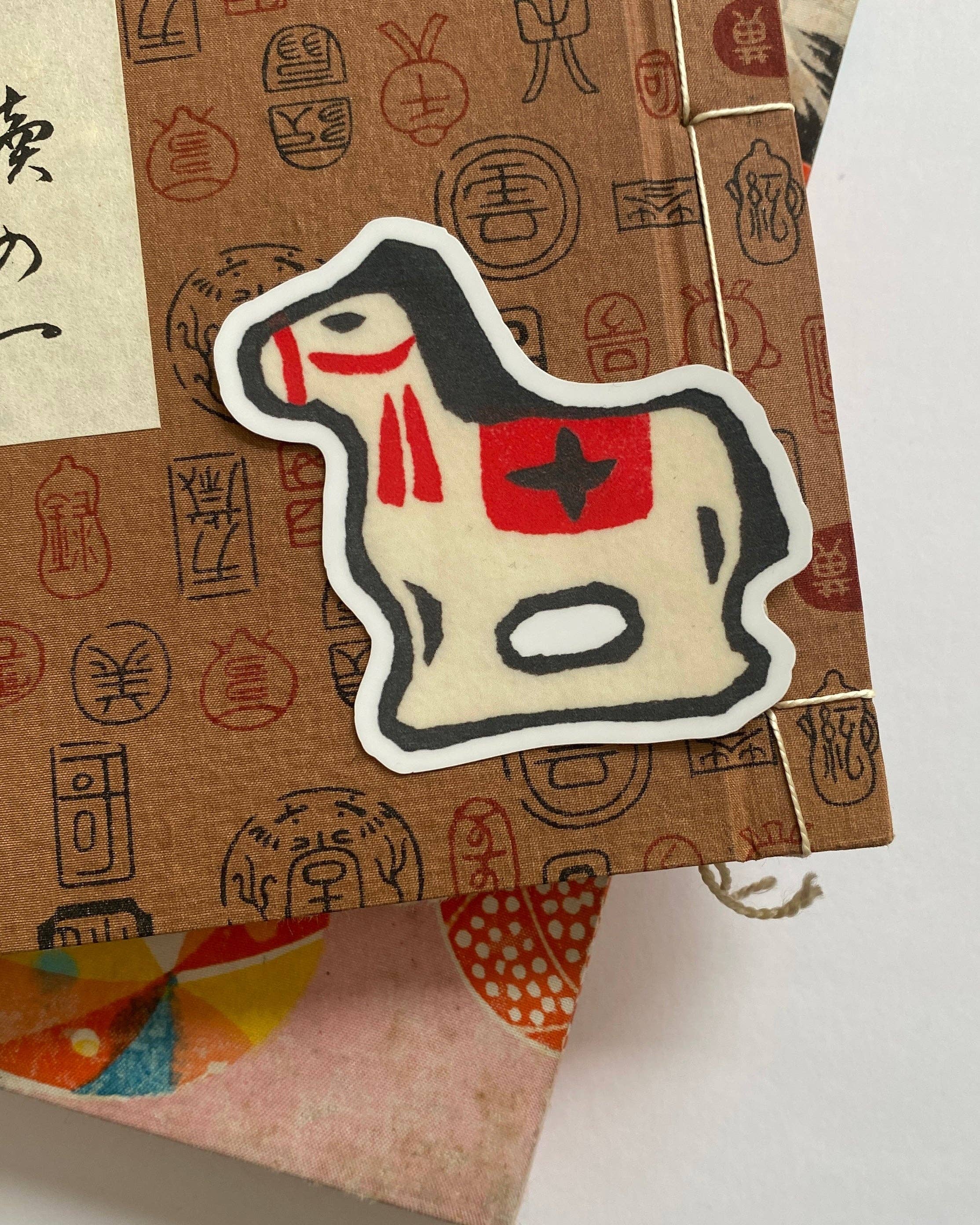 Sticker of a horse with a red star on a textured background