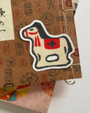 Sticker of a horse with a red star on a textured background