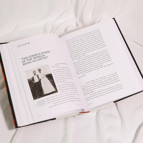 Open book on a white surface with text and an image of a couple.
