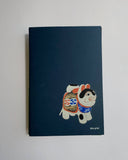 Notebook with a cartoon dog design on a blue background